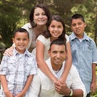 Happy Hispanic Family Portrait In the Park